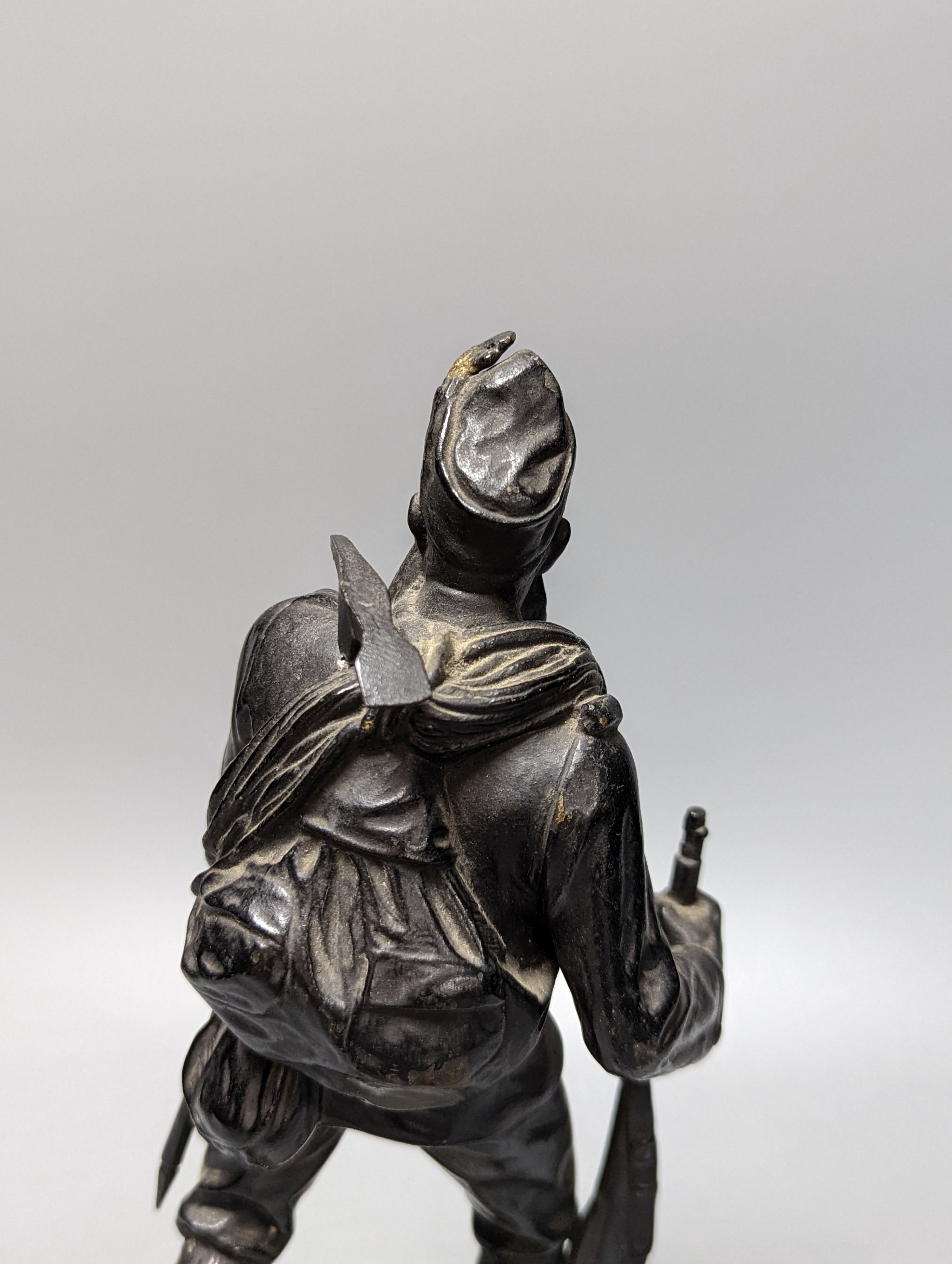 A WW1 period bronze figure of an Austrian soldier, 30 cms high including stone base.